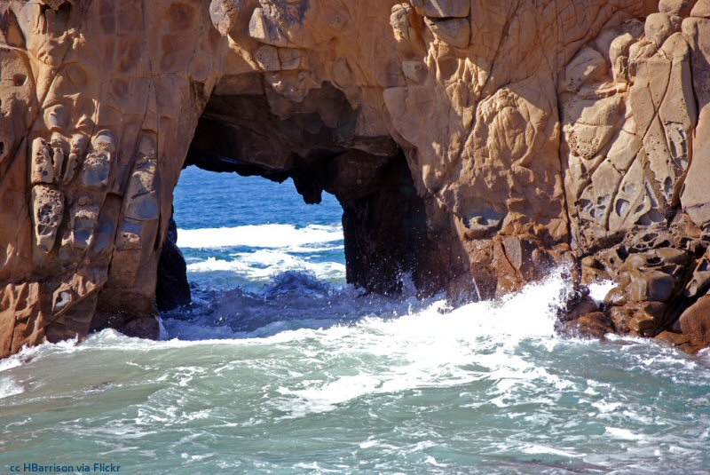 Daylight and high tide view of Keyhole Arch at Pfeiffer Beach, Big Sur